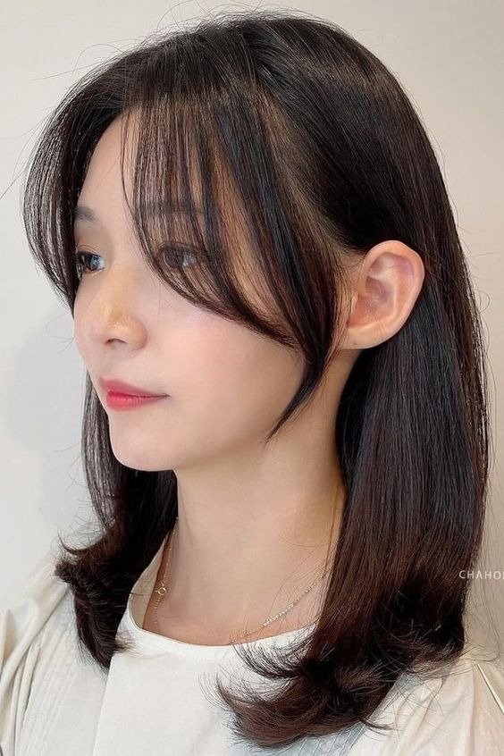 Chic and Trendy Korean Haircut Ideas: 9. Wispy or See-Through Bangs: Light and Feathery